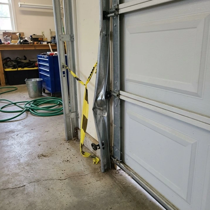 Bent garage door track requiring professional repair