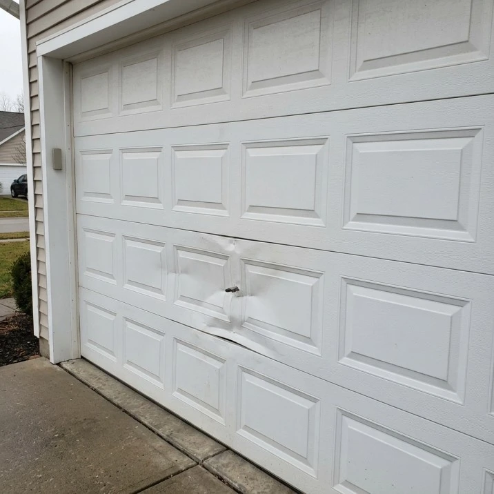 Damaged garage door panel in Tuscaloosa Alabama