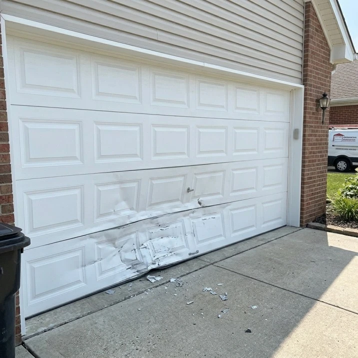 Garage door panel damage before replacement in Tuscaloosa