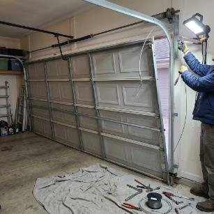 Snapped Lift Cable → Door hanging unevenly off-track; replaced cable & realigned track alignment